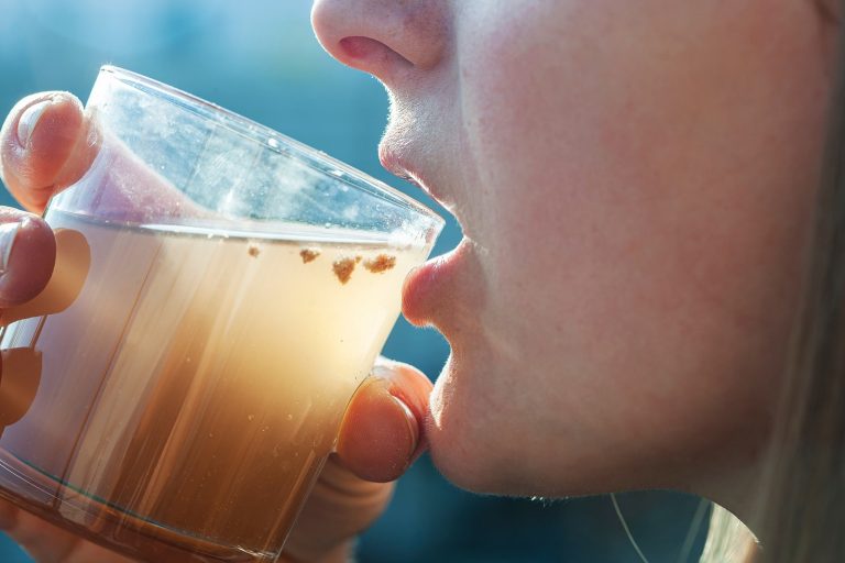 woman drinking dirty water