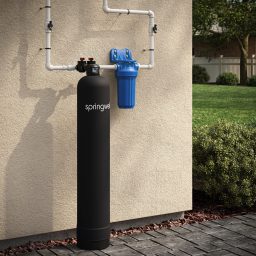 SpringWell CF1 and CF4 whole house water filter installed outside a home