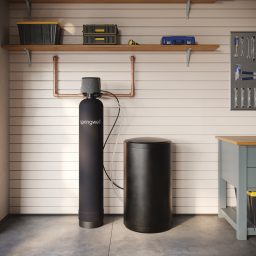 SpringWell SS1 salt based water softener installed in a basement